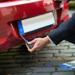 Man Changing Car’s Number Plate
