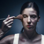 Close up portrait of a crying woman with bruised skin and black eyes