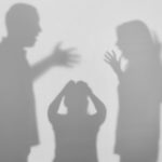 Silhouettes of quarreling parents and little child on white background. Domestic violence concept