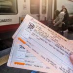 Woman holding train tickets on Milano Centrale train station